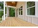 Inviting covered porch with wood flooring, offering a cozy outdoor space at 1036 Dell Se Ave, Smyrna, GA 30080