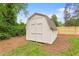 Backyard shed with double doors nestled amidst a well-maintained lawn and perimeter trees at 1036 Dell Se Ave, Smyrna, GA 30080