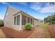 Home exterior featuring a screened in porch with access to a well maintained yard at 1335 Seneca, Cumming, GA 30041