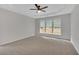Bright carpeted bedroom with a ceiling fan and large windows overlooking the backyard at 1335 Seneca, Cumming, GA 30041