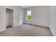 Bright bedroom featuring neutral carpet, large closet, and a window with a backyard view at 1335 Seneca, Cumming, GA 30041