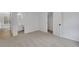Carpeted bedroom with an open door to a bathroom, with a view to a hallway at 1335 Seneca, Cumming, GA 30041