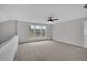 Spacious bonus room featuring a ceiling fan, large windows, neutral walls, and carpet at 1335 Seneca, Cumming, GA 30041