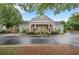 The community building has a covered entrance, lush landscaping, and ample parking at 1335 Seneca, Cumming, GA 30041
