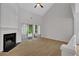 Spacious living room featuring a fireplace, vaulted ceilings, and sliding door to the deck at 1335 Seneca, Cumming, GA 30041
