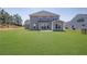 Expansive backyard featuring lush green lawn and a patio area, perfect for outdoor entertaining at 307 Ernest Ave, Peachtree City, GA 30269