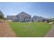 Large grassy backyard of gray home, offering ample space for recreation and activities at 307 Ernest Ave, Peachtree City, GA 30269