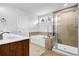 Bright bathroom featuring a shower with glass door, tub, and tile accents for a relaxing retreat at 307 Ernest Ave, Peachtree City, GA 30269