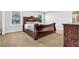 Bedroom with natural light streaming through a window, highlighting the elegant wood furniture and plush carpeting at 307 Ernest Ave, Peachtree City, GA 30269