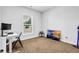 Bedroom with large window, neutral carpet, and desk space at 307 Ernest Ave, Peachtree City, GA 30269