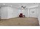 Spacious bedroom featuring neutral walls and carpet, complemented by a ceiling fan and natural light from the window at 307 Ernest Ave, Peachtree City, GA 30269