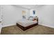 Cozy bedroom with neutral walls, a window providing natural light, and plush carpeting at 307 Ernest Ave, Peachtree City, GA 30269
