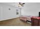 Bright bedroom with a ceiling fan, a window providing natural light, and neutral-colored carpet at 307 Ernest Ave, Peachtree City, GA 30269