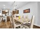 Dining area with a modern light fixture, table, seating for six, and hardwood flooring at 307 Ernest Ave, Peachtree City, GA 30269