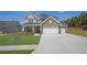 Two story home with mixed stone and vinyl siding, manicured lawn and 3-car garage at 307 Ernest Ave, Peachtree City, GA 30269