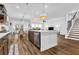 Well-lit kitchen featuring a large island, pendant lighting, stainless steel appliances, and an open floor plan at 307 Ernest Ave, Peachtree City, GA 30269