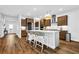 Spacious kitchen with a large island, pendant lighting, dark wood cabinetry, and hardwood floors at 307 Ernest Ave, Peachtree City, GA 30269