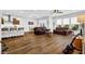 Open-concept living room featuring hardwood floors, leather couches, and stainless steel appliances at 307 Ernest Ave, Peachtree City, GA 30269