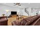 Spacious living room features hardwood floors, ceiling fan, and comfortable leather couches at 307 Ernest Ave, Peachtree City, GA 30269
