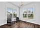 Cozy sitting room with large windows, natural light, and hardwood flooring at 307 Ernest Ave, Peachtree City, GA 30269
