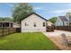 A fenced backyard with lush lawn, trees, and a rock-lined patio area at 3412 Orchard St, Atlanta, GA 30354