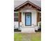 Close-up of a beautiful blue front door with decorative accents, and a well-kept front yard at 3412 Orchard St, Atlanta, GA 30354