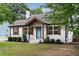 Charming home with a well-maintained lawn, stone pathway, and a delightful blue front door at 3412 Orchard St, Atlanta, GA 30354