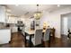 Bright kitchen and dining area featuring white cabinets, granite countertops, and modern appliances at 3412 Orchard St, Atlanta, GA 30354