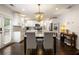 Bright kitchen and dining area featuring white cabinets, granite countertops, and modern appliances at 3412 Orchard St, Atlanta, GA 30354