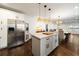 Open kitchen design with island seating, stainless steel refrigerator, and seamless flow to dining area at 3412 Orchard St, Atlanta, GA 30354