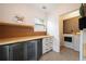 The light and airy laundry room has great storage, including overhead shelving at 3412 Orchard St, Atlanta, GA 30354