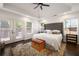 Spacious main bedroom with tray ceiling, large windows, and access to a deck at 3412 Orchard St, Atlanta, GA 30354