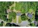 Aerial view highlights a home nestled among mature trees, showcasing its location within a verdant community at 407 Yellowstone Dr, Powder Springs, GA 30127