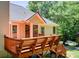 Inviting backyard deck with wood railings, access to the home's interior, and views of the landscaped yard at 407 Yellowstone Dr, Powder Springs, GA 30127