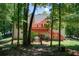 The backyard features a deck, mature trees, and ample space for outdoor gatherings and recreation at 407 Yellowstone Dr, Powder Springs, GA 30127