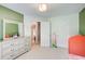 Well-lit bedroom showcasing neutral carpet, a large dresser, and a closet at 407 Yellowstone Dr, Powder Springs, GA 30127