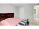 Comfortable bedroom featuring a plush bed, neutral walls, and a window providing natural light at 407 Yellowstone Dr, Powder Springs, GA 30127