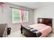 Cozy bedroom with soft carpet, warm lighting, and a window offering natural light at 407 Yellowstone Dr, Powder Springs, GA 30127