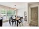 Sunlit dining room with modern chandelier, large windows, and wood-style flooring at 407 Yellowstone Dr, Powder Springs, GA 30127