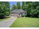 Charming home boasts well-manicured lawn, classic curb appeal, attached garage, and inviting entrance at 407 Yellowstone Dr, Powder Springs, GA 30127