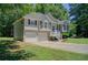 Beautiful home with a well-maintained lawn, two-car garage, and lush landscaping at 407 Yellowstone Dr, Powder Springs, GA 30127