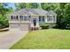 Charming two-story home with a well-manicured lawn, mature trees, and a two-car garage at 407 Yellowstone Dr, Powder Springs, GA 30127