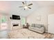 Cozy living room with vaulted ceilings, fireplace, ceiling fan, and view of the backyard at 407 Yellowstone Dr, Powder Springs, GA 30127