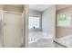 Main bathroom featuring a glass enclosed shower and a large soaking tub at 407 Yellowstone Dr, Powder Springs, GA 30127