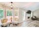 Bright sun room featuring multiple windows, hardwood floors, and cozy seating at 407 Yellowstone Dr, Powder Springs, GA 30127