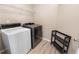 Functional laundry area equipped with modern washer and dryer units and convenient shelving for storage at 191 Orchard Dr, Canton, GA 30115