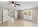 Spacious room featuring new floors, ceiling fan, and access to the back porch and stairs at 191 Orchard Dr, Canton, GA 30115