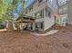 Backyard with a deck, a patio, and steps with pine straw ground cover at 2435 Roxburgh Dr, Roswell, GA 30076