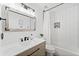 Bathroom featuring a tile shower with black hardware and a light wood vanity at 2435 Roxburgh Dr, Roswell, GA 30076