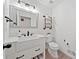 Bright half bath featuring shiplap walls, updated fixtures, and a stylish vanity with modern design at 2435 Roxburgh Dr, Roswell, GA 30076